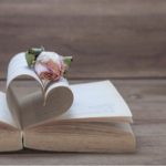 Open Book With Pages In The Shape Of A Heart With Rose In Center