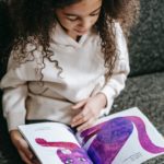Young girl reading Eric Carle book