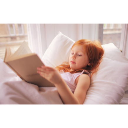 Young girl reading lying down