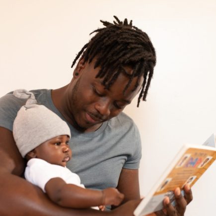 Father reading to his baby