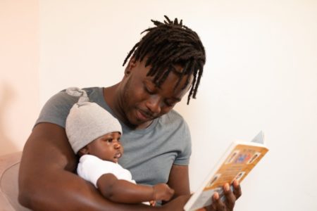 Father reading to his baby