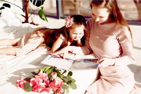 Mother Reading a book to her daughter